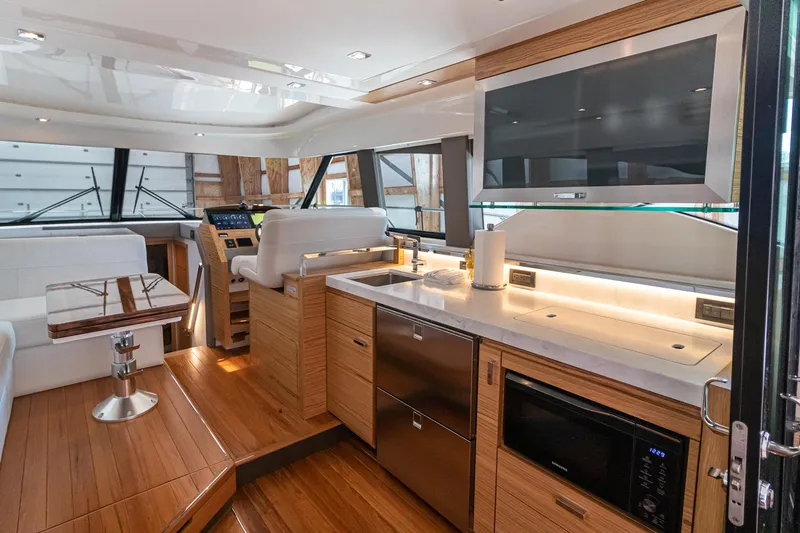 Noor Yacht Photos Pics Interior of 2023 Tiara Yachts C44 Coupe, featuring modern kitchen and seating area.