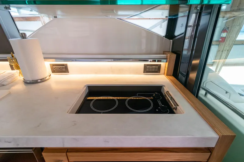 Noor Yacht Photos Pics Modern kitchen area in 2023 Tiara Yachts C44 Coupe with sleek induction cooktop.