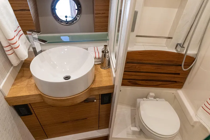 Noor Yacht Photos Pics 2023 Tiara Yachts C44 Coupe bathroom with modern sink, toilet, and shower.
