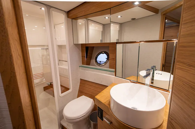 Noor Yacht Photos Pics Luxurious bathroom in 2023 Tiara Yachts C44 Coupe with modern fixtures and wood accents.
