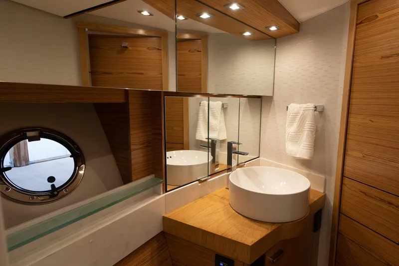 Noor Yacht Photos Pics Luxurious bathroom in 2023 Tiara Yachts C44 Coupe with modern fixtures and wood accents.