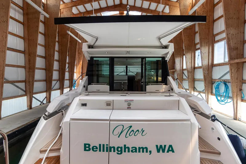 Noor Yacht Photos Pics 2023 Tiara Yachts C44 Coupe docked in a wooden boathouse, named "Noor" from Bellingham, WA.