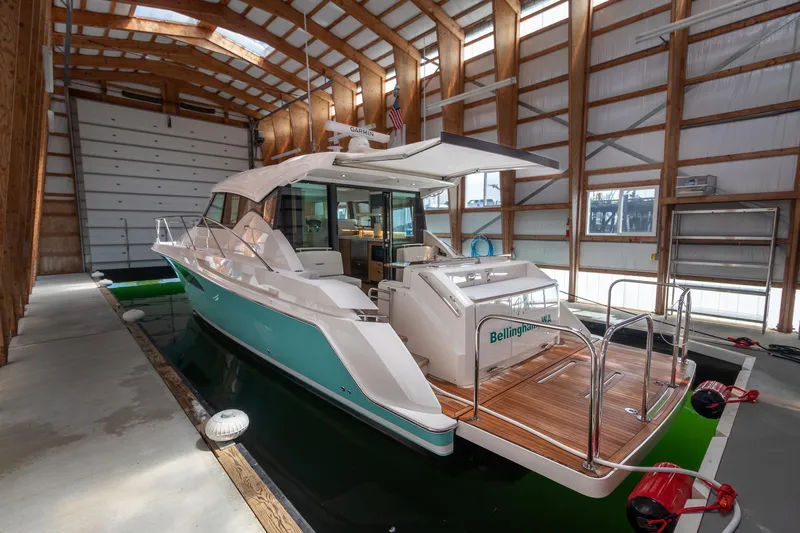 Noor Yacht Photos Pics 2023 Tiara Yachts C44 Coupe in a boathouse, showcasing sleek design and luxury features.