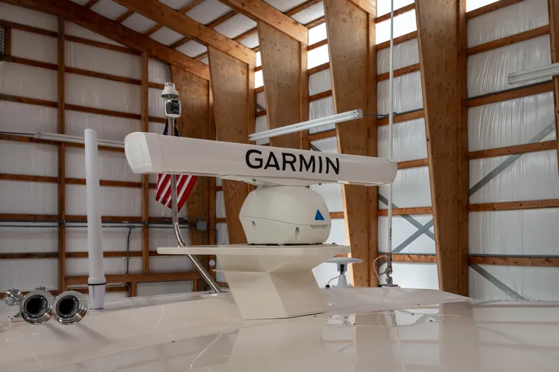 Noor Yacht Photos Pics 2023 Tiara Yachts C44 Coupe with Garmin radar in a wooden boathouse.