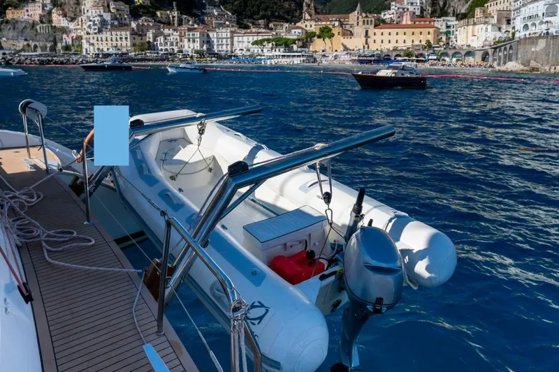  Yacht Photos Pics Lagoon 500 yacht with dinghy, 2011 model, docked near scenic coastal town.