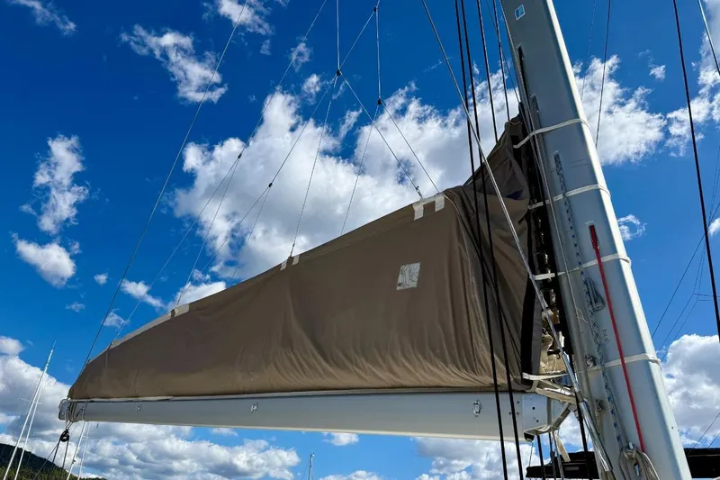  Yacht Photos Pics Sail of 2011 Lagoon 500 catamaran against a bright blue sky with clouds.