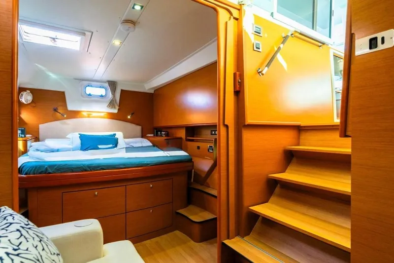  Yacht Photos Pics Luxurious cabin interior of 2011 Lagoon 500 yacht with wooden finish and cozy bed.