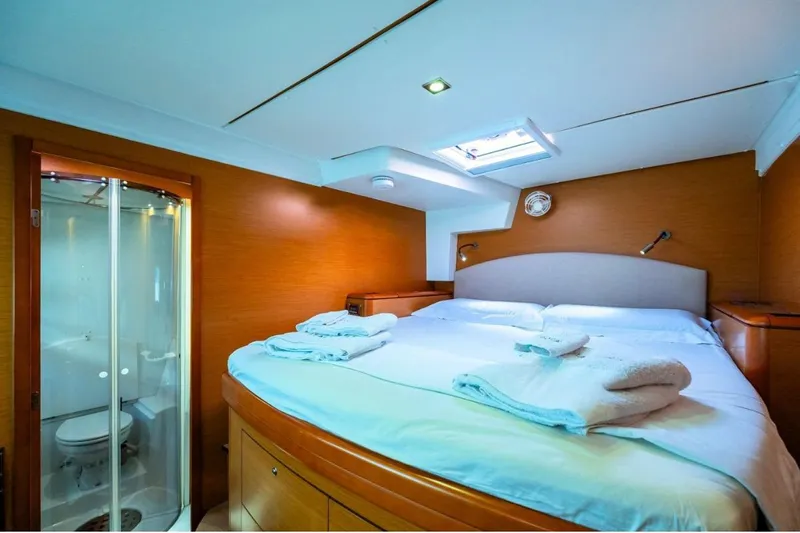  Yacht Photos Pics Luxurious cabin interior of 2011 Lagoon 500 yacht with cozy bed and ensuite bathroom.