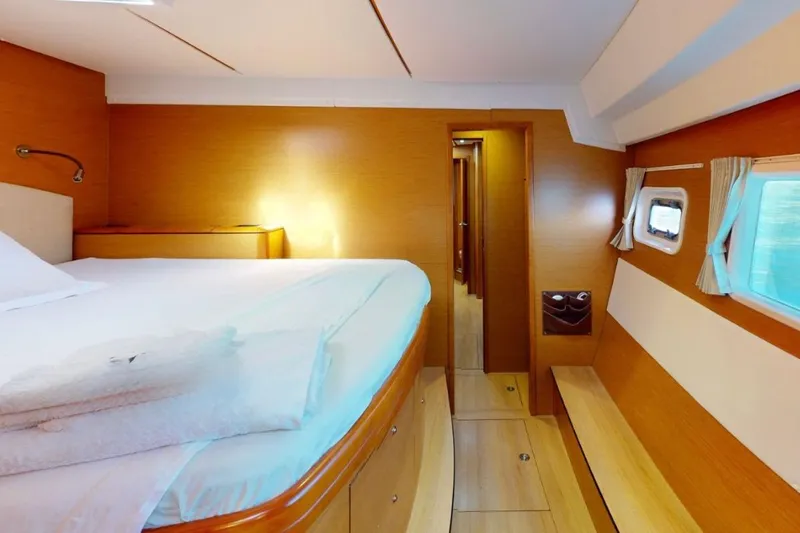 Yacht Photos Pics Luxurious cabin interior of 2011 Lagoon 500 yacht with cozy bed and wooden finish.