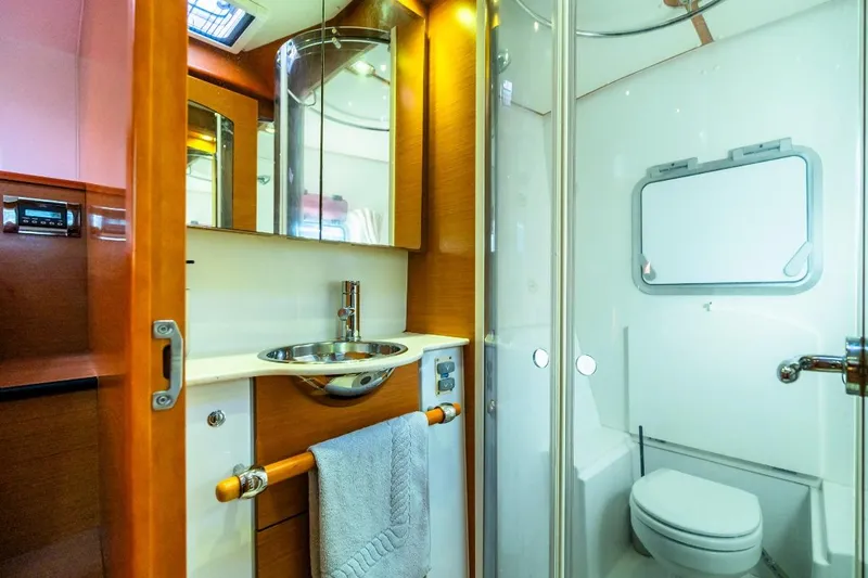  Yacht Photos Pics Luxurious bathroom interior of 2011 Lagoon LAGOON 500 yacht, featuring modern fixtures and wood accents.