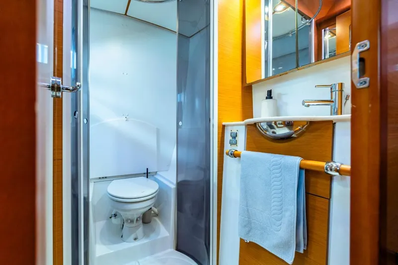  Yacht Photos Pics Bathroom interior of 2011 Lagoon LAGOON 500 yacht, featuring modern fixtures and wooden accents.
