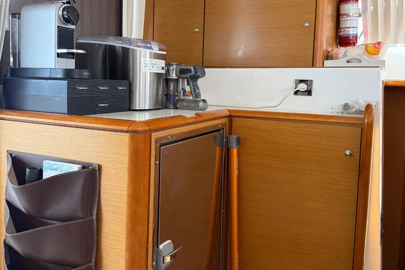  Yacht Photos Pics Interior of 2011 Lagoon 500 yacht with coffee maker and wooden cabinetry.