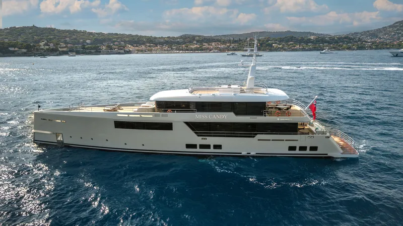 Miss Candy Yacht Photos Pics Luxurious 2022 Versilcraft HS yacht cruising on a serene ocean backdrop.
