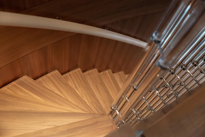 Miss Candy Yacht Photos Pics Spiral wooden staircase with metal railing on Versilcraft HS yacht, 2022 model.