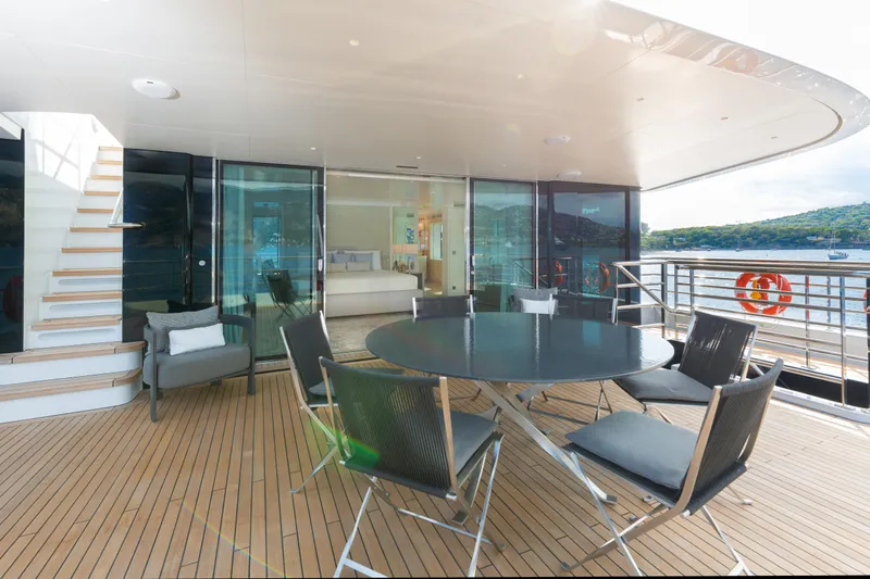Miss Candy Yacht Photos Pics Luxurious Versilcraft HS 2022 yacht deck with modern seating and scenic ocean view.
