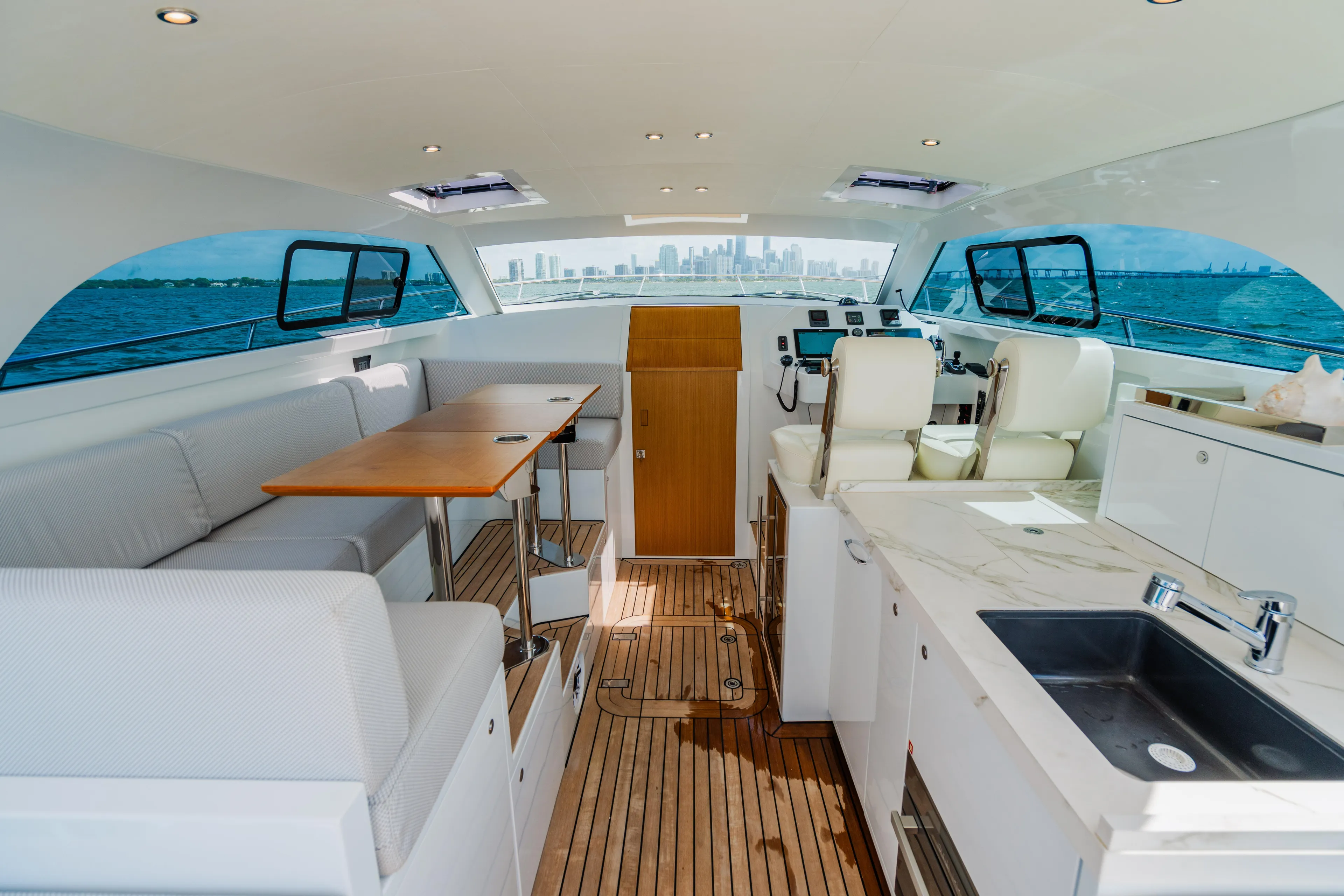 Mojo Yacht Photos Pics Interior of 2022 Anka 45 Coupe Cruiser yacht with modern seating and kitchen area.