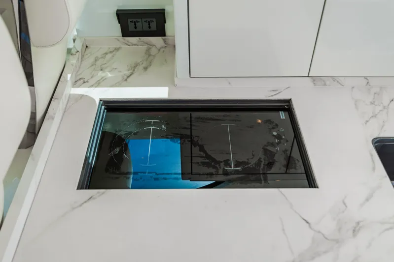 Mojo Yacht Photos Pics 2022 Anka 45 Coupe Cruiser interior with marble countertop and built-in induction cooktop.
