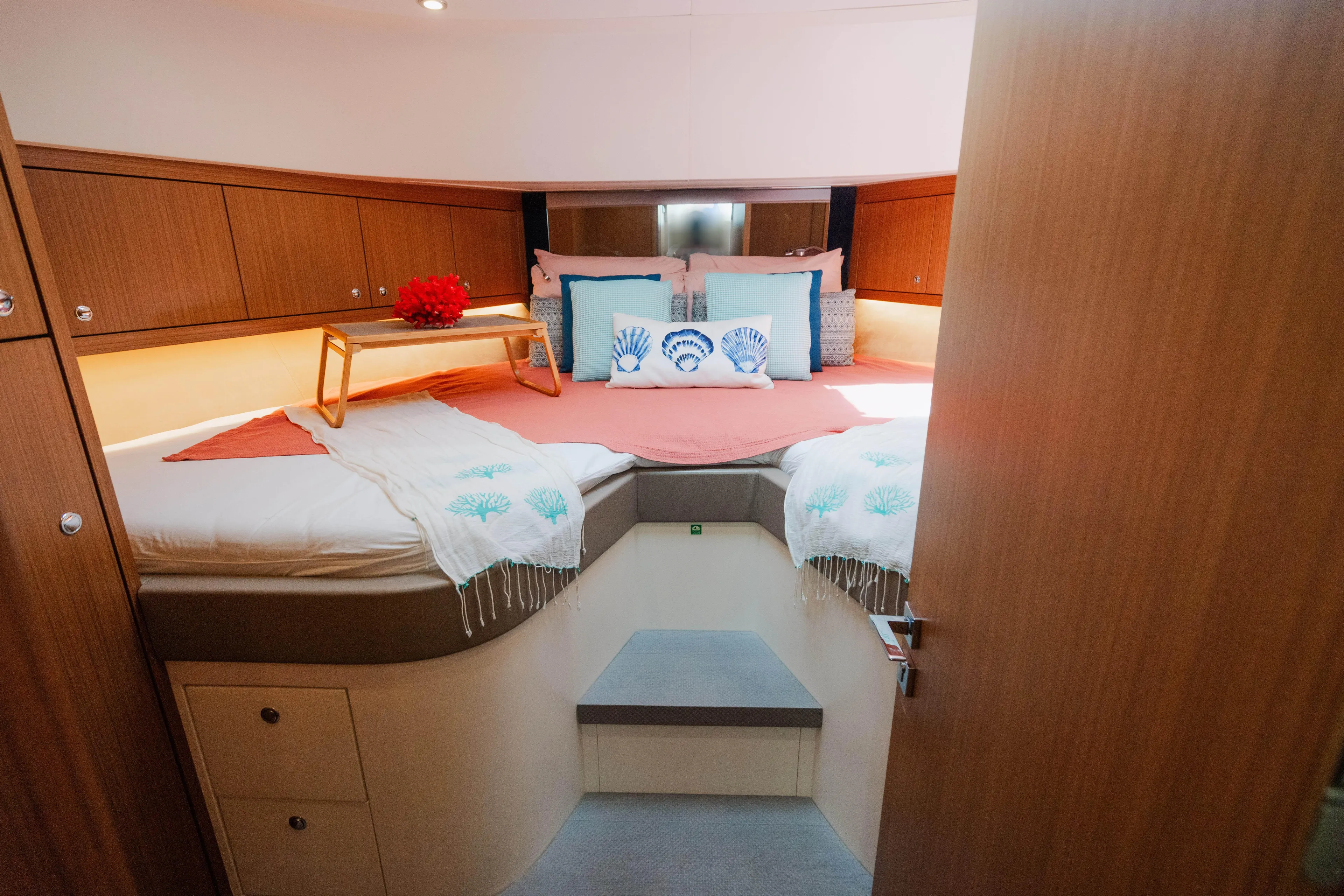 Mojo Yacht Photos Pics Luxurious bedroom in 2022 Anka 45 Coupe Cruiser with cozy bedding and wooden cabinets.