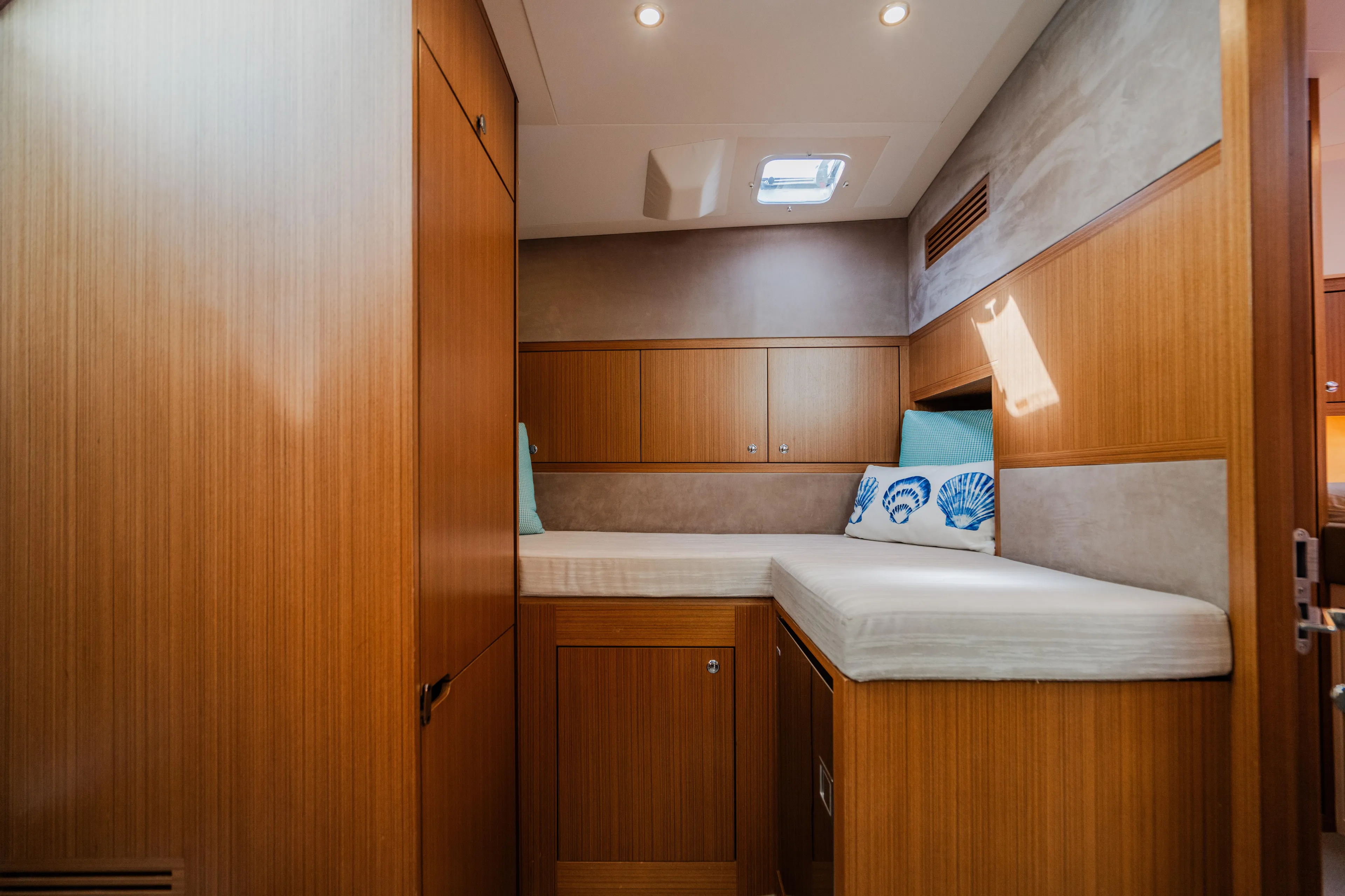 Mojo Yacht Photos Pics 2022 Anka 45 Coupe Cruiser cabin with wooden interior and cozy bedding.