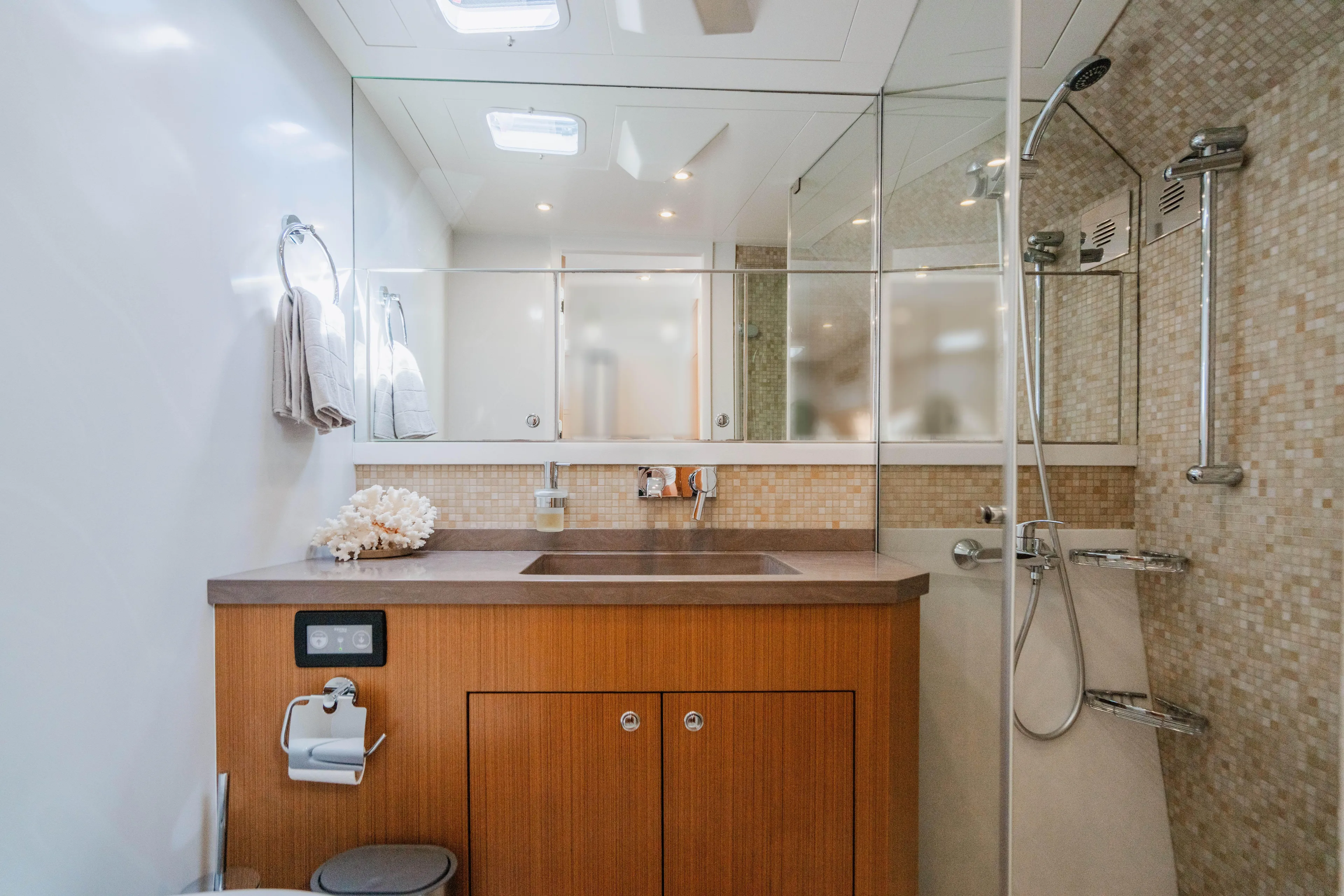 Mojo Yacht Photos Pics Modern bathroom in 2022 Anka 45 Coupe Cruiser with wooden cabinetry and glass shower.