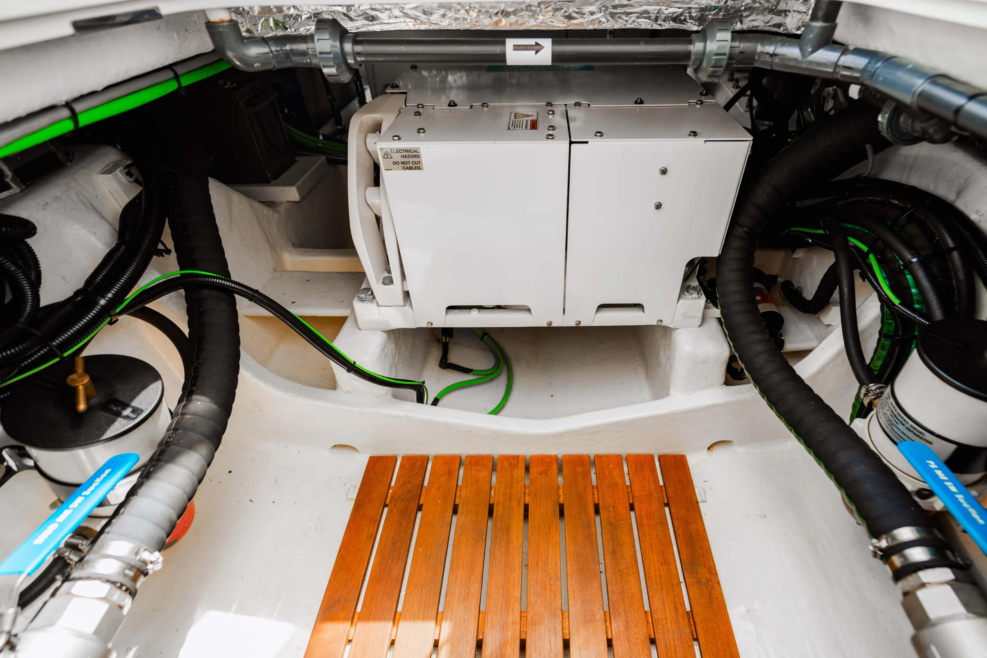 Mojo Yacht Photos Pics Engine compartment of a 2022 Anka 45 Coupe Cruiser with wooden flooring.