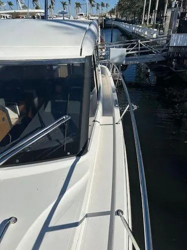 This Could Be Yours Yacht Photos Pics 2023 Bavaria R40 Coupe yacht docked at marina with palm trees.