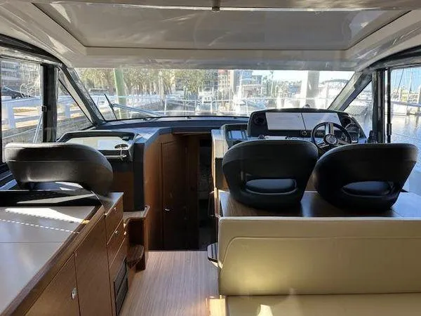 This Could Be Yours Yacht Photos Pics Interior of 2023 Bavaria R40 Coupe yacht with modern helm and seating area.