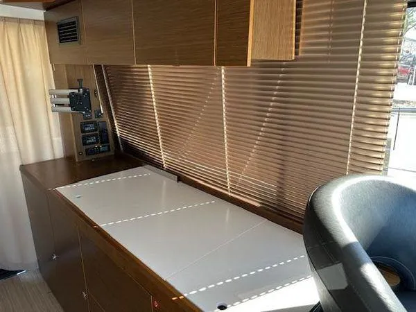 This Could Be Yours Yacht Photos Pics Interior of 2023 Bavaria R40 Coupe with wooden cabinetry and modern design.