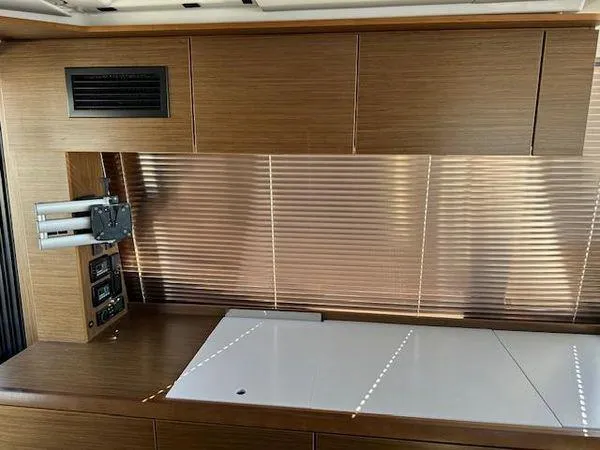 This Could Be Yours Yacht Photos Pics Interior of 2023 Bavaria R40 Coupe with wooden cabinetry and modern design elements.