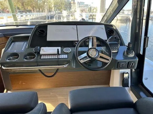 This Could Be Yours Yacht Photos Pics 2023 Bavaria R40 Coupe helm with modern controls and dual displays.