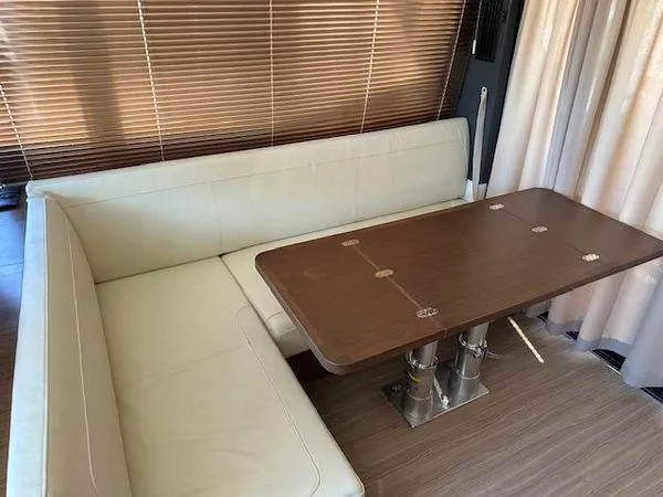 This Could Be Yours Yacht Photos Pics Luxurious interior of 2023 Bavaria R40 Coupe with elegant seating and wooden table.