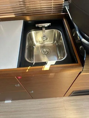 This Could Be Yours Yacht Photos Pics 2023 Bavaria R40 Coupe kitchen sink with modern faucet and wooden cabinetry.