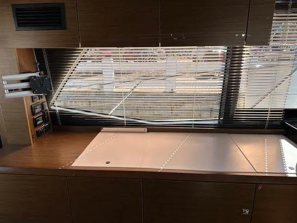 This Could Be Yours Yacht Photos Pics Interior of 2023 Bavaria R40 Coupe yacht with sleek wooden cabinetry and large window blinds.