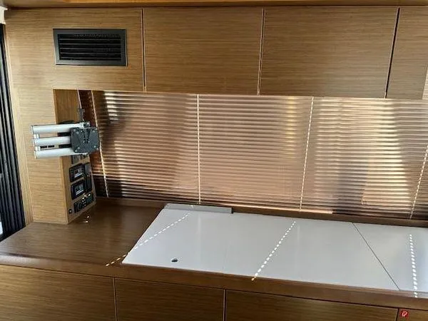 This Could Be Yours Yacht Photos Pics 2023 Bavaria R40 Coupe interior with sleek wooden cabinetry and modern design elements.