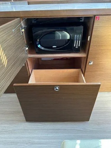 This Could Be Yours Yacht Photos Pics Wooden cabinet with microwave and drawer in 2023 Bavaria R40 Coupe.