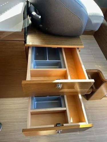 This Could Be Yours Yacht Photos Pics 2023 Bavaria R40 Coupe interior with open wooden drawers and storage compartments.