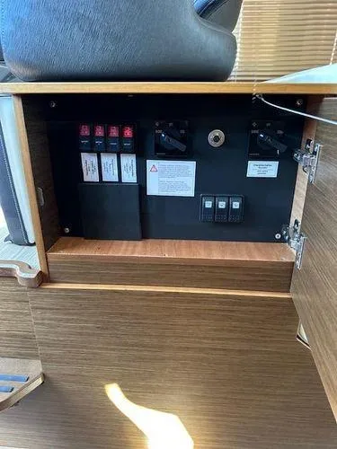 This Could Be Yours Yacht Photos Pics Electrical panel inside 2023 Bavaria R40 Coupe yacht, featuring switches and circuit breakers.