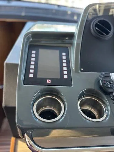 This Could Be Yours Yacht Photos Pics 2023 Bavaria R40 Coupe dashboard with touchscreen and dual cup holders.