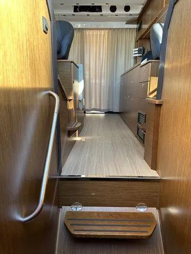 This Could Be Yours Yacht Photos Pics Interior of 2023 Bavaria R40 Coupe, featuring wooden flooring and modern cabinetry.