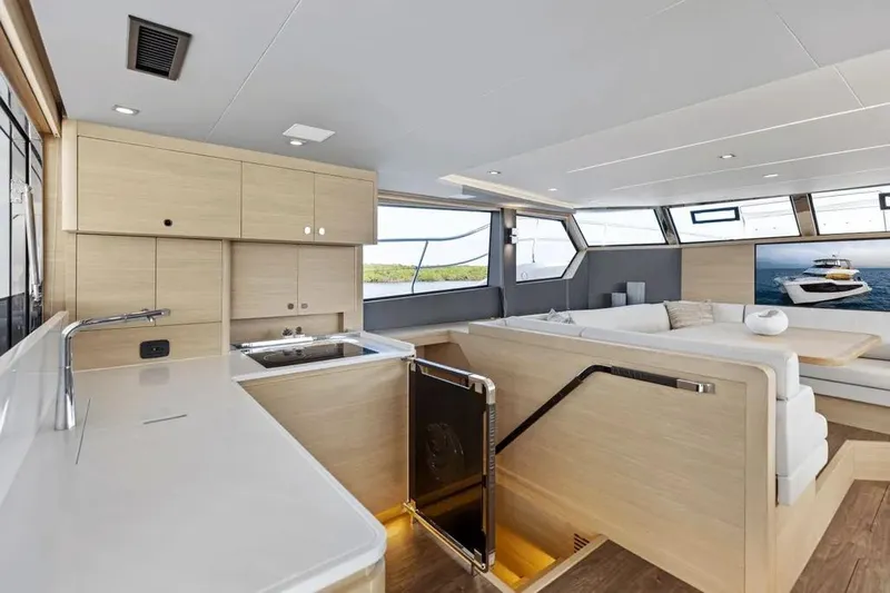  Yacht Photos Pics Luxurious interior of 2025 Aquila 50 Yacht with modern kitchen and seating area.