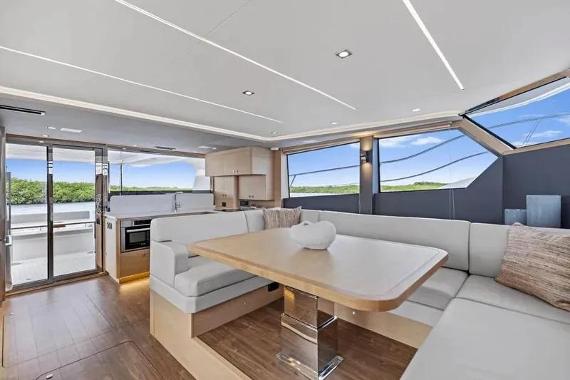  Yacht Photos Pics Luxurious interior of 2025 Aquila 50 Yacht with modern seating and panoramic windows.