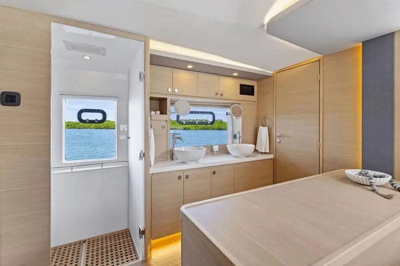  Yacht Photos Pics Luxurious interior of 2025 Aquila 50 Yacht with modern bathroom and scenic window view.
