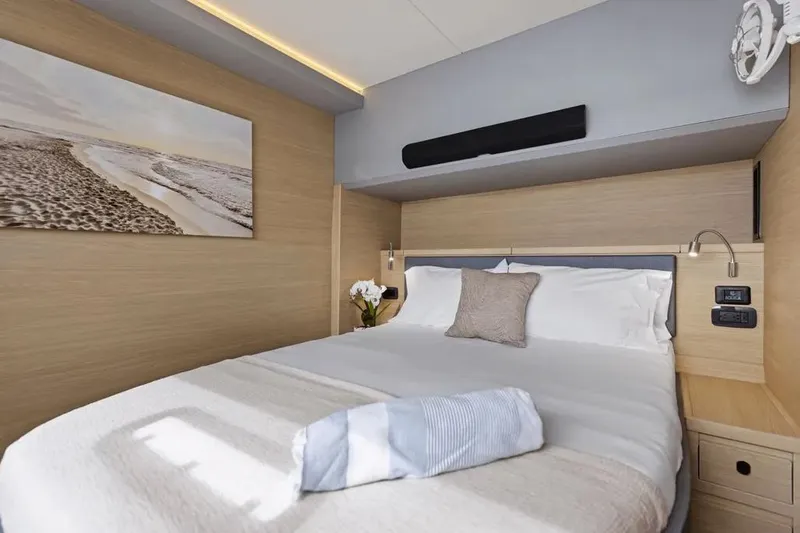  Yacht Photos Pics Luxurious bedroom interior of 2025 Aquila 50 Yacht with modern decor and cozy bedding.
