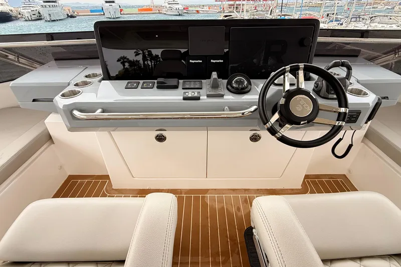  Yacht Photos Pics Helm of 2025 Aquila 50 Yacht with modern controls and steering wheel.