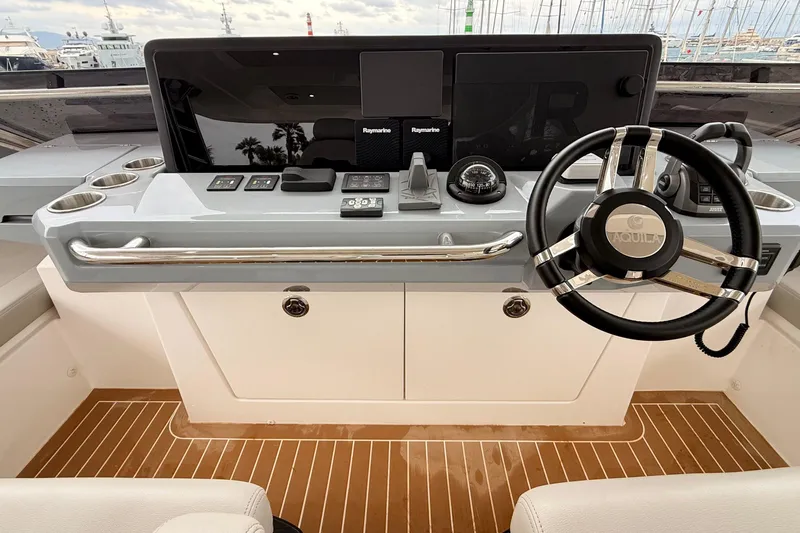  Yacht Photos Pics Helm of 2025 Aquila 50 Yacht with modern controls and steering wheel.