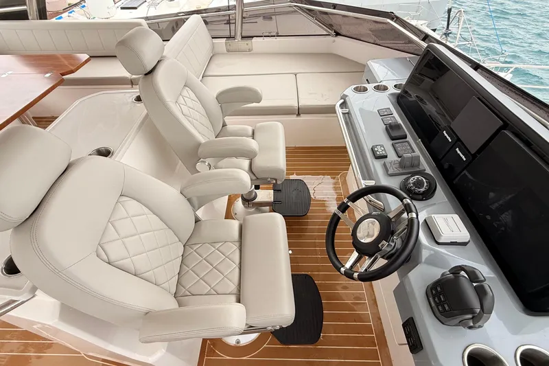  Yacht Photos Pics 2025 Aquila 50 Yacht helm with luxurious seating and advanced navigation controls.