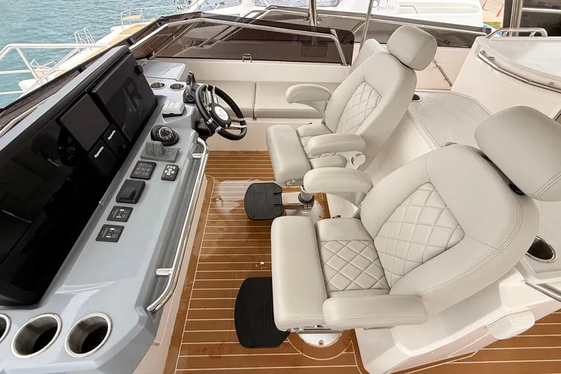  Yacht Photos Pics 2025 Aquila 50 Yacht helm with luxurious seating and advanced navigation controls.