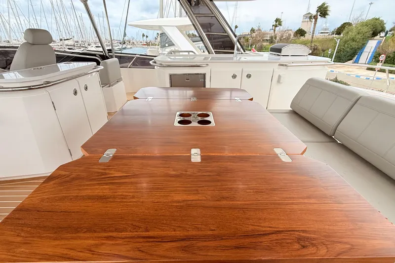 Yacht Photos Pics Luxurious interior of 2025 Aquila 50 Yacht with elegant wooden table and seating.
