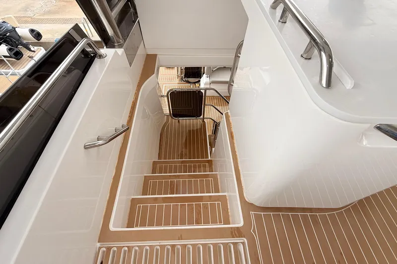  Yacht Photos Pics Staircase on 2025 Aquila 50 Yacht with sleek design and wooden accents.