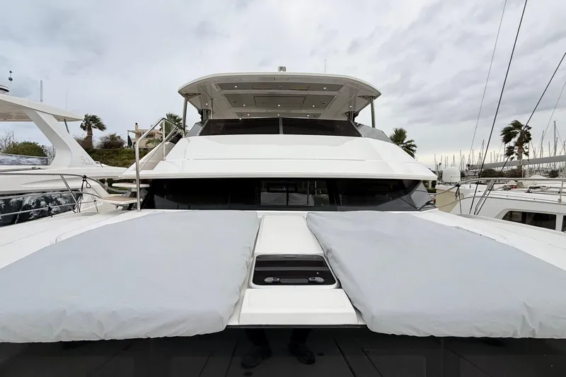  Yacht Photos Pics 2025 Aquila 50 Yacht docked, showcasing sleek design and spacious deck.